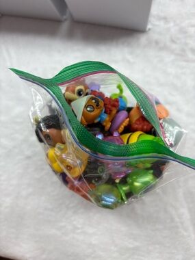 57 of assorted Disney doorables in this bag